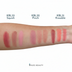 Lip color swatches on a arm with 'Vhues Beauty' branding