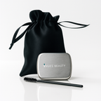 Black satin drawstring bag with a silver case and black brush on a white background, featuring 'Hues Beauty' branding.